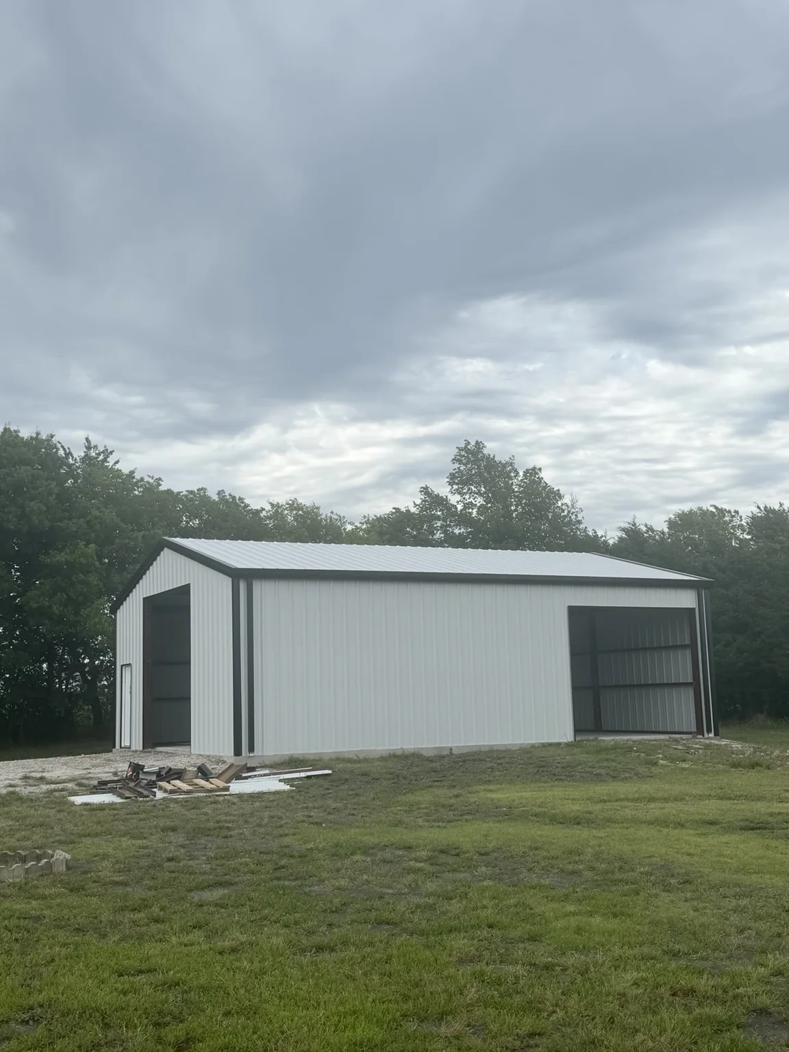 White metal shop building with black trim