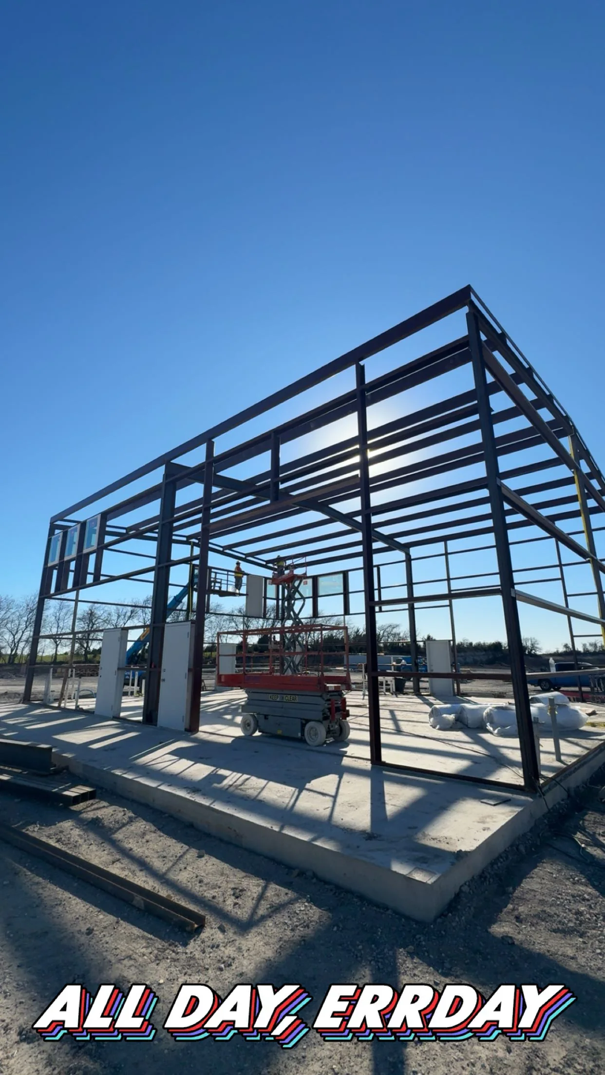 Completed dark metal building in a wooded East Texas setting