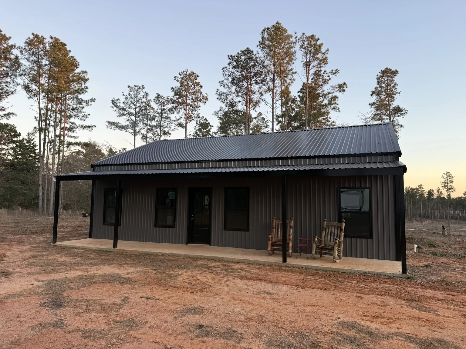 Red iron building frame on concrete slab