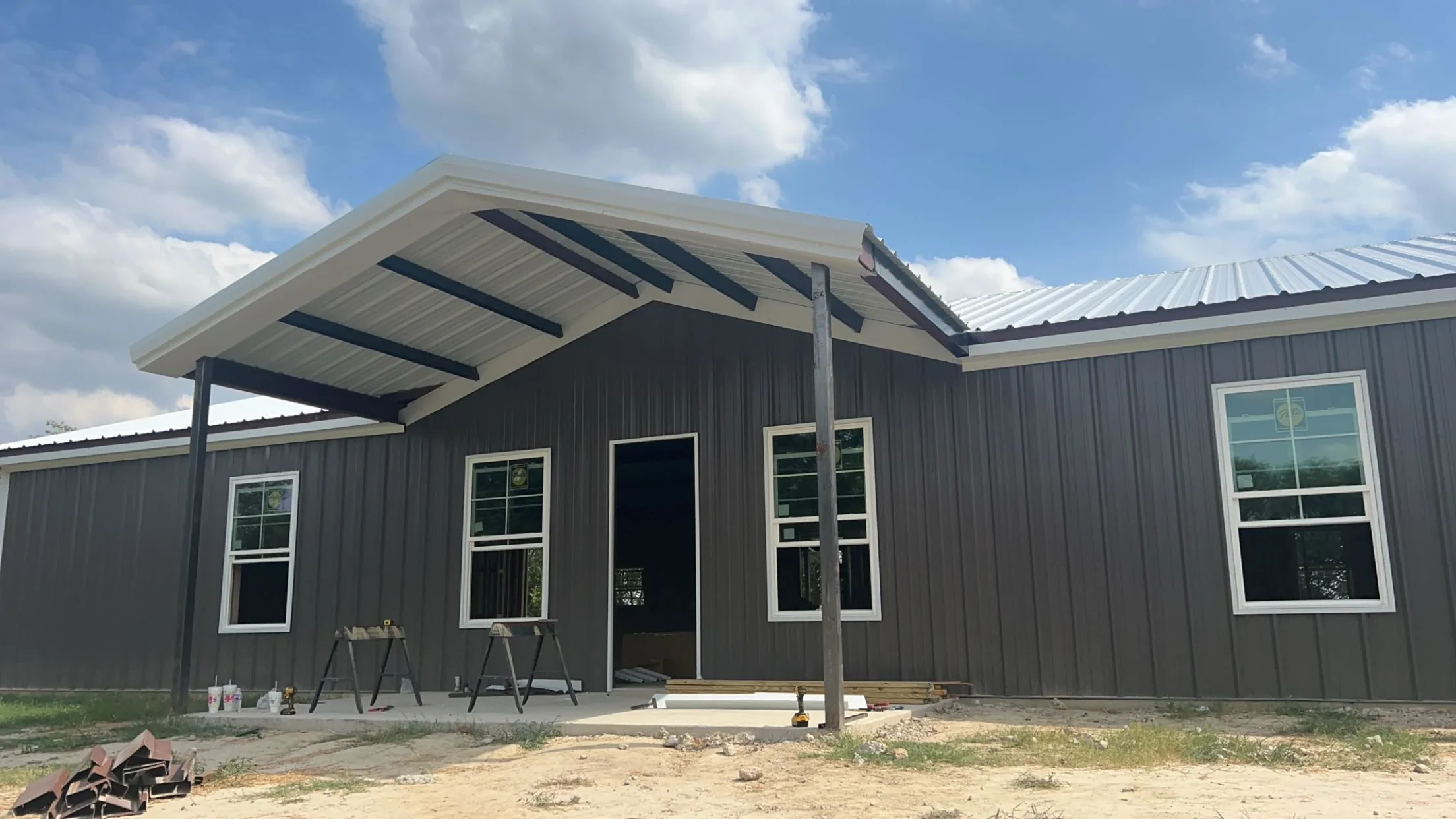 Covered porch on a dark gray metal building